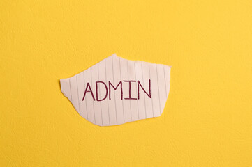 Torn paper written with text ADMIN isolated on yellow background