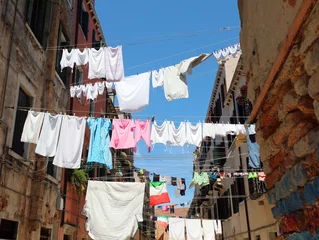 Foto op Canvas clothes hanging out drying in the sun in the narrow street of the typical Italian city © ChiccoDodiFC