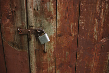 Metal padlock on old wooden gate, rustic rural wallpaper, wood texture on old door