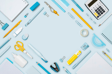 School and office stationery on blue background with copy space