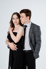  young couple in suits on white background.