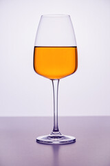 A close-up of a glass filled with pure red wine on the white background. Plain surface, no splashes. Restaurant glassware, serve, romance, passion, love, party.