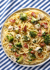 Homemade Chicken Bacon Broccoli Alfredo on a gray plate, top view. Flat lay, overhead, from above.