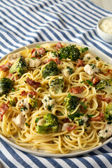 Homemade Chicken Bacon Broccoli Alfredo on a plate, side view.