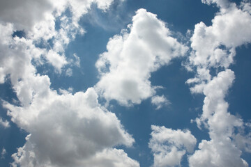 Blue sky and cottony clouds on a partly cloudy and bright day.  Cumulus clouds. copy space.