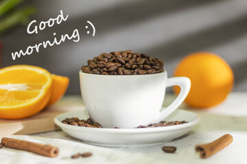 White cup with coffee beans and the text good morning