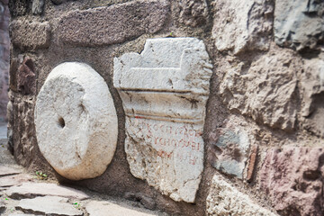 The walls of the Ankara Castle, built with stones of different sizes, previously used in other ancient buildings.  Wood frame and  doors.