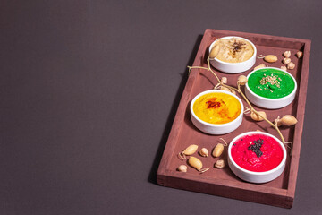 Fototapeta na wymiar Colorful hummus bowls, healthy vegan dips