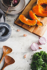 Top view of roasted pumpkin slices on a wooden board. Cooking concept, seasonal fall background.