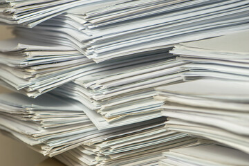 Bundles bales of paper documents. stacks packs pile on the desk in the office. waste paper, paper trash