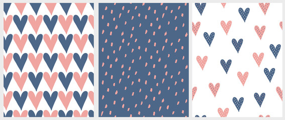 Cute Hand Drawn Romantic Seamless Vector Patterns. Blue and Pink Hearts Isolated on a White Background. Simple Infantile Style Geometric Print with Irregular Spots on a Dark Blue Backdrop. © Magdalena