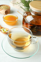 Concept of cooking chamomile tea on white wooden table