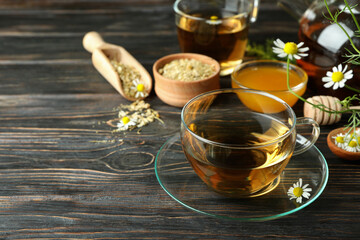 Concept of cooking chamomile tea on rustic wooden table