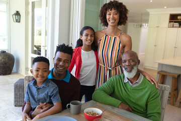 Portrait of smiling african american multi generation family sitting at table during breakfast