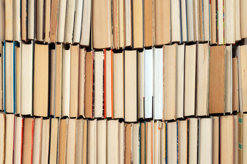 Vintage book background. Old and used hardback books stacked next to each other. Concept of education and studying. Nobody