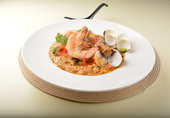 stir fried dry bee hoon mee noodle with mixed seafood lala shell and prawn in Thai tomyum spicy sauce asian halal menu