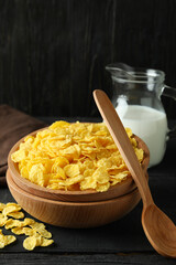 Concept of tasty breakfast with cornflakes on wooden table
