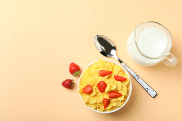 Concept of tasty breakfast with cornflakes on beige background