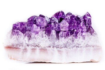 Macro mineral stone purple amethyst in crystals on a white background