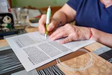 Model Release Form is Being Signed by Hands of an Elderly Woman at Home