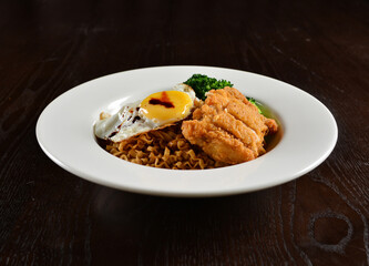 stir fried dry instant noodle mee indo in dark soya sauce with fried egg and crispy chicken chop asian halal menu