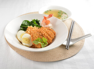 stir fried dry instant noodle mee indo in dark soya sauce with fried egg and crispy chicken chop and soup asian halal menu