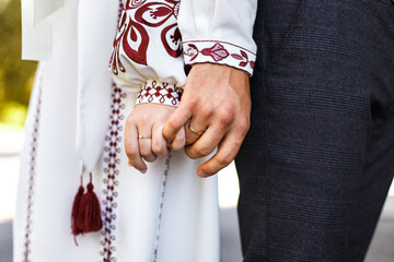 Young couple holding hands tightly