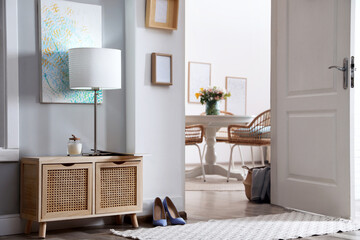 Light hallway with open door to room. Interior design