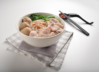 cook fresh meat ball and slices pork with bee hoon noodle mee vermicelli hot soup in bowl asian healthy menu
