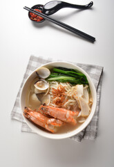 big tiger prawn seafood Lala with bee hoon noodle mee soup hot asian menu in bowl 