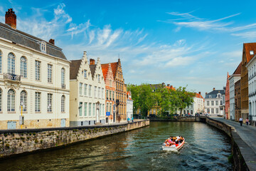 Naklejka premium Tourist boat in canal. Brugge Bruges, Belgium