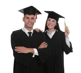 Happy students in academic dresses on white background