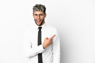 Business caucasian man isolated on white background surprised and pointing side
