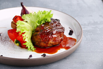 grilled filet mignon close up with vegetables on concrete table