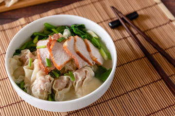 Wonton food with dumpling and roasted pork in bowl as local Chinese food