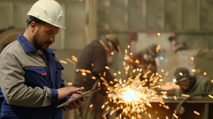 Engineer using Tablet PC in heavy industry factory 