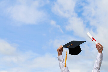 Education. happy students in gowns are celebrating graduation Throwing hands up a certificate and...