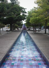 Interesting portuguese street style art: time and place to rest in Caminho da Aqua, Lisbon. Extraordinary fantastic volcano fountain, water road stream into fantasy pink and purple tiles alley