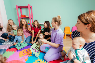 Lovely babies and their mothers at the nursery or daycare