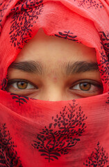 Closeup of beautiful woman face covered with hijab. Perfect brown crystal and shiny eyes of a...