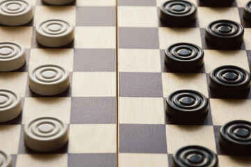 checkers. a board game for brains, strategy. black and white figures. - obrazy, fototapety, plakaty
