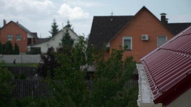 Rainwater Pouring on Gutter on Edge of Metal Roof. Heavy Rain Storm Water Drops Raindrops Fall on Drain Drainage System. Country Village Rural House Cottage. Overcast Sky Day. 2x Slow motion 60fps 4K