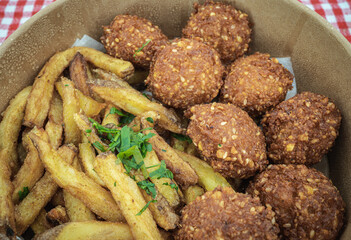 Falafel and french fries, close up view from above