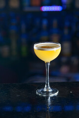yellow refreshing coctail on a bar desk