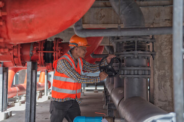 senior worker  working open vale in plant