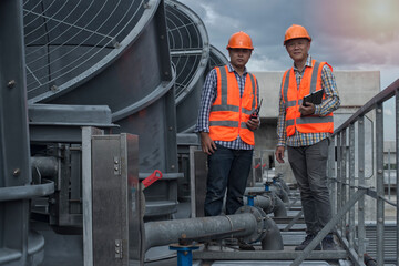 work standing and looking camera on cooling tower