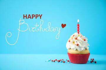 Happy Birthday! Delicious cupcake with candle on light blue background