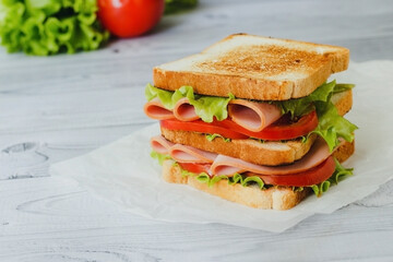 sandwich with ham, salad and tomato