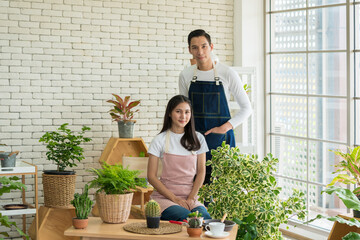 Portrait of Young Entrepreneur, Plant sellers opened the Online floral plant shop in the house. Florist or Gardeners working in a garden nursery. E commerce shopping, Small delivery business from home