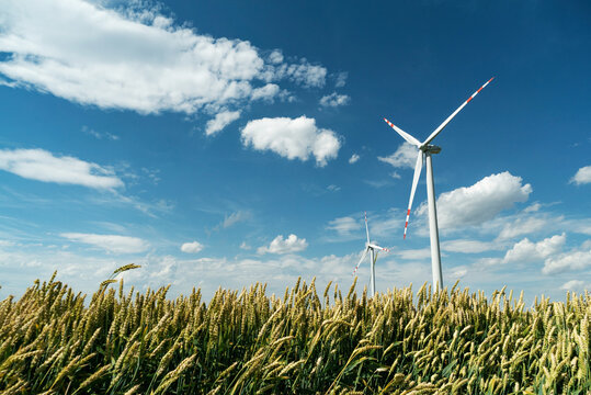 Wind turbines in the country filelds. Turbines farm.Village from drone aerial view. Beautiful village with houses and fields in Nysa, Poland. Polish farmland